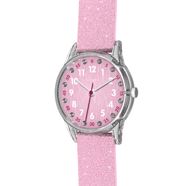 Eine Kinder-Armbanduhr mit einem rosa Glitzerarmband, transparentem Gehäuse und kleinen Schmucksteinen auf dem Ziffernblatt. Die weißen Zahlen auf dem rosa Ziffernblatt sind sehr gut ablesbar.